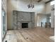 Open-concept living room with a stone fireplace, high ceilings, and hardwood floors offers a cozy atmosphere at 5841 Powell Rd, Parker, CO 80134
