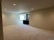 Spacious living room with neutral carpet, a bar and ample natural light from the window at 5841 Powell Rd, Parker, CO 80134
