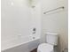 Bright bathroom with white tiled shower and a matching toilet for a clean and modern design at 14125 Deertrack Ln, Parker, CO 80134