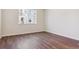 Bed room features hardwood floors, white trim, large window for natural light at 14125 Deertrack Ln, Parker, CO 80134