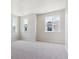 Spacious bedroom with neutral walls and carpeting, showcasing ample natural light from large windows at 14125 Deertrack Ln, Parker, CO 80134