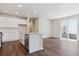 Bright kitchen featuring a center island, subway tile backsplash, stainless steel appliances, and wood floors at 14125 Deertrack Ln, Parker, CO 80134