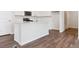 Bright kitchen featuring a center island, quartz countertops, stainless steel appliances, and wood flooring at 14125 Deertrack Ln, Parker, CO 80134