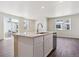 Open-concept kitchen boasts a center island with seating, sink, and a stainless steel dishwasher at 14125 Deertrack Ln, Parker, CO 80134