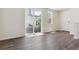Living area has wood flooring, a sliding glass door to the outside, and white trim at 14125 Deertrack Ln, Parker, CO 80134