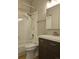 Cozy bathroom featuring tiled shower-tub combination and dark-toned vanity at 886 Summer Dr, Highlands Ranch, CO 80126