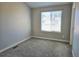 Bedroom features carpet and a large window overlooking the neighborhood at 886 Summer Dr, Highlands Ranch, CO 80126