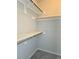 Organized closet featuring white shelves and wooden rods for optimal storage solutions at 886 Summer Dr, Highlands Ranch, CO 80126