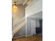 Hallway with hardwood floors, white trim staircase, and modern lighting at 886 Summer Dr, Highlands Ranch, CO 80126