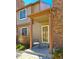 Charming front entrance with a cozy porch, a chair, and a combination of brick and siding at 886 Summer Dr, Highlands Ranch, CO 80126