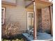 Cozy front porch with a chair and brick column detail at 886 Summer Dr, Highlands Ranch, CO 80126