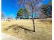 Landscaped grounds with mature trees set against a bright blue sky at 886 Summer Dr, Highlands Ranch, CO 80126