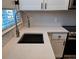 Up close view of kitchen with stainless steel faucet and sink, and tiled backsplash at 886 Summer Dr, Highlands Ranch, CO 80126