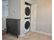 Modern laundry area with stackable washer and dryer, and convenient storage at 886 Summer Dr, Highlands Ranch, CO 80126