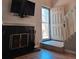 Inviting living room showcasing a fireplace, television, and hardwood floors near the entryway at 886 Summer Dr, Highlands Ranch, CO 80126
