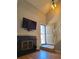 Cozy living room with fireplace, TV, and staircase with natural light at 886 Summer Dr, Highlands Ranch, CO 80126