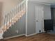Stairway with white railing and wood steps, next to storage cabinet at 886 Summer Dr, Highlands Ranch, CO 80126