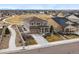 Expansive aerial view of a two-story home with well-manicured landscaping in a suburban neighborhood at 745 Penstemon Dr, Henderson, CO 80640