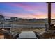 Beautiful sunset view from backyard seating area overlooking community green space perfect for relaxing or entertaining guests at 745 Penstemon Dr, Henderson, CO 80640