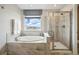 Serene bathroom with a soaking tub and walk-in shower at 745 Penstemon Dr, Henderson, CO 80640