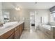 Stylish Primary bathroom with a double vanity, soaking tub, and luxurious finishes at 745 Penstemon Dr, Henderson, CO 80640