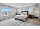 Bright bedroom with a large bed, neutral tones, and natural light at 745 Penstemon Dr, Henderson, CO 80640