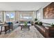 Bright living room featuring large windows, plush seating, and stylish decor at 745 Penstemon Dr, Henderson, CO 80640