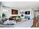 Comfortable living room featuring a fireplace, stylish furniture and decor at 745 Penstemon Dr, Henderson, CO 80640