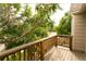 Wood deck balcony surrounded by lush trees at 9617 W Chatfield Ave # E, Littleton, CO 80128