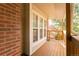 Balcony view showcasing multiple windows, brick wall, and wooden railing and supports at 9617 W Chatfield Ave # E, Littleton, CO 80128