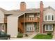 Charming townhome with two-story design, wood staircase, and well-maintained landscaping at 9617 W Chatfield Ave # E, Littleton, CO 80128
