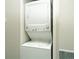 Laundry area featuring a stacked washer and dryer unit at 9617 W Chatfield Ave # E, Littleton, CO 80128