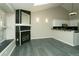 Living room featuring natural light, fireplace, open kitchen, and luxury vinyl flooring at 9617 W Chatfield Ave # E, Littleton, CO 80128
