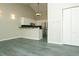 Open concept living room and kitchen with vaulted ceilings, neutral paint, and pendant lighting at 9617 W Chatfield Ave # E, Littleton, CO 80128