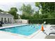 Community pool with lounge chairs and mature trees at 9617 W Chatfield Ave # E, Littleton, CO 80128
