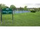 Dakota Station Park featuring a fenced tennis court, lush grass, and a walking area at 9617 W Chatfield Ave # E, Littleton, CO 80128
