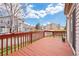 A spacious back deck with a red-stained wooden railing with a view at 5596 S Urban St, Littleton, CO 80127