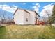 Spacious backyard with a wooden deck, grass, and a privacy fence at 5596 S Urban St, Littleton, CO 80127