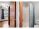 Bathroom featuring a wood door, neutral wall color, and bathtub with shower at 5596 S Urban St, Littleton, CO 80127