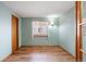 Light and airy bedroom with hardwood floors, a window, and a door at 5596 S Urban St, Littleton, CO 80127