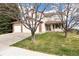 Charming two-story home with a three-car garage and a well-manicured front lawn at 5596 S Urban St, Littleton, CO 80127