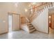 Inviting foyer with tile flooring, a staircase, and decorative glass front door at 5596 S Urban St, Littleton, CO 80127