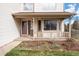 Inviting front porch with a covered entryway and well-kept landscaping at 5596 S Urban St, Littleton, CO 80127