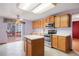 Charming kitchen with stainless steel appliances, island, and outdoor deck access at 5596 S Urban St, Littleton, CO 80127