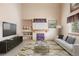 Bright living room with a fireplace, TV, and neutral decor at 5596 S Urban St, Littleton, CO 80127