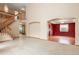 Spacious living area featuring a staircase, archway, and an open floor plan at 5596 S Urban St, Littleton, CO 80127