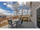 View of the wooden backyard deck with chairs and a table with a view of the neighborhood at 19593 E Hollow Creek Dr, Parker, CO 80134