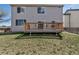 View of the wooden backyard deck with chairs and a grill, perfect for outdoor entertaining at 19593 E Hollow Creek Dr, Parker, CO 80134