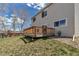 View of the wooden backyard deck that is perfect for outdoor entertaining, with a glimpse of the neighborhood at 19593 E Hollow Creek Dr, Parker, CO 80134