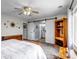Bedroom with large window, ceiling fan and decorative mirrors at 19593 E Hollow Creek Dr, Parker, CO 80134